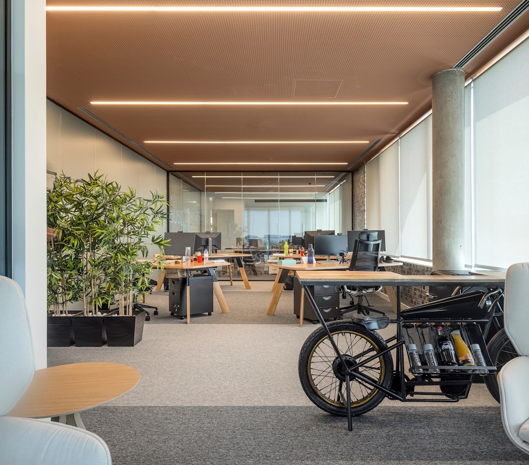 Team of colleagues talking in a modern office hallway