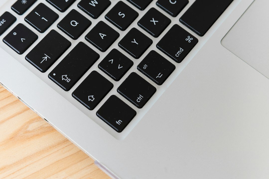 Close-up of hands typing on a laptop keyboard